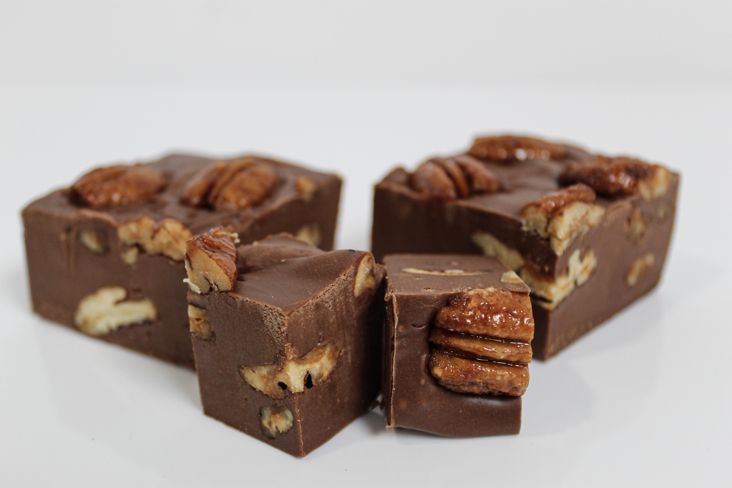Chocolate pecan fudge cut to show house-roasted Texas pecans set throughout the slab